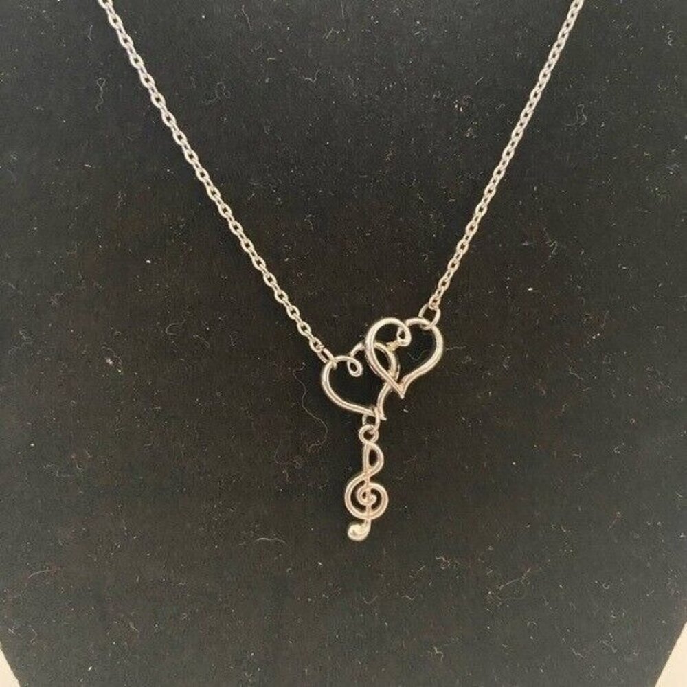 Lovely silver-tone necklace with treble clef and two hearts for music lover